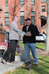 Warren Monette of New England Landscaping and Construction receiving a certificate of appreciation for the work he did on the project.